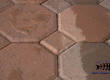 close up of hexagon blocks on ground with water droplets on them