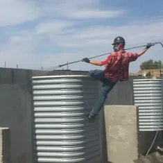 a worker spraying solution on a concrete wall