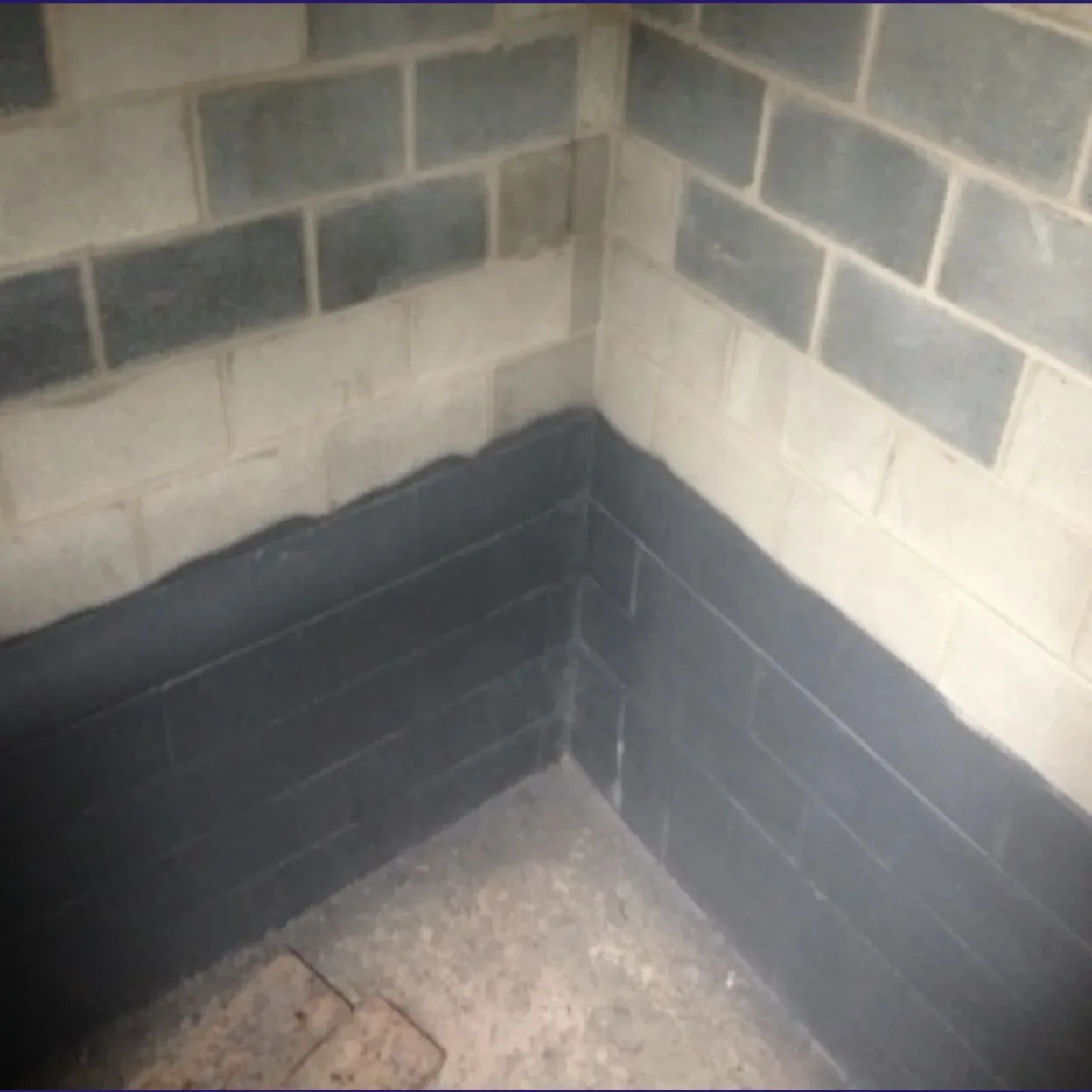 image of a brick wall with the bottom painted black